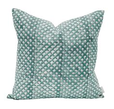 a green and white pillow on a white background