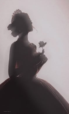 the silhouette of a woman in a dress with a flower on her left hand, holding a rose