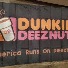 the dunkin'deeznut sign is hanging on the wall