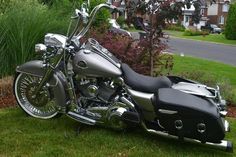 a silver and black motorcycle parked in the grass