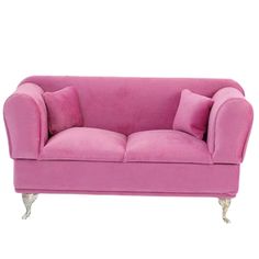 a pink couch sitting on top of a white floor