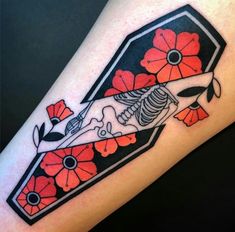 a tattoo on the arm of a woman with flowers and a skeleton in it's body