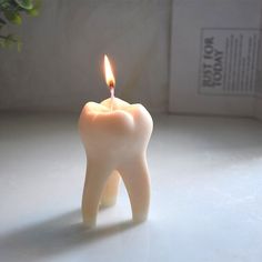 a tooth shaped candle sitting on top of a table