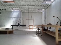 an empty room with tables, chairs and other items on the floor in front of them