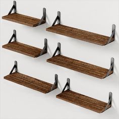 four wooden shelves with metal brackets on them