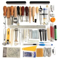 an assortment of different tools are displayed on a white surface with rulers, scissors and other items