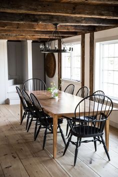 a dining room table and chairs with wooden floors