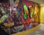 the wall is decorated with colorful butterflies and flowers on it's glass paneling