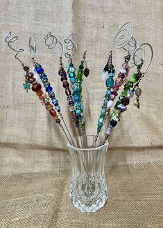 a glass vase filled with lots of colorful beads