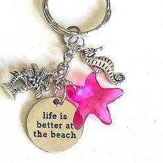 a keychain with a starfish and seahorse on it that says life is better at the beach