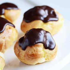 chocolate frosted donuts on a white plate