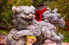 a statue of a lion in front of a red building