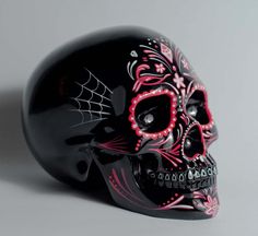 a black skull with red and white designs on it