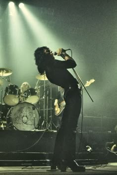 a man on stage singing into a microphone