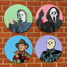 four halloween coasters on a brick wall with the faces of three characters painted on them