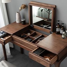 a wooden desk with drawers and a mirror