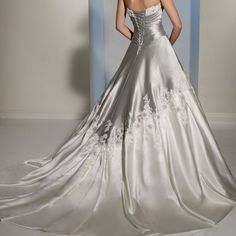 a woman in a white wedding dress standing next to a blue and white striped wall