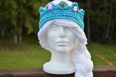 a crocheted hat on top of a white mannequin head