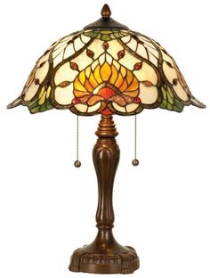 a table lamp with a stained glass shade on it's base and beading