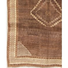 an antique rug with brown and beige colors