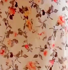 an image of a flowered curtain with red and yellow flowers on it's side