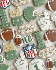 decorated cookies are arranged in the shape of footballs