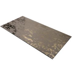 a brown and black area rug sitting on top of a white floor