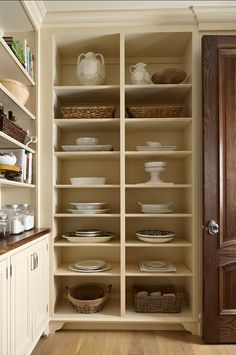 the pantry is stocked with dishes and plates