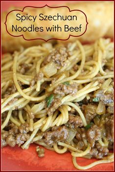 spaghetti with meat and vegetables on a red plate