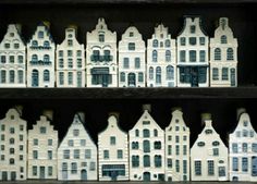 some white and blue buildings are on shelves