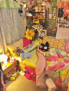 a messy bedroom with lots of stuffed animals on the bed and toys all over the room