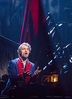 an image of a screen shot of a man on stage with the caption mark karninoo as jean vealen in les miserables merlerables photo by mattev murphy