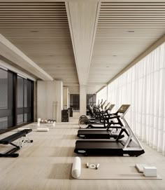 there are many treadmills lined up on the floor near each other in this room