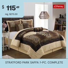 a bed room with a leopard print comforter and pillows