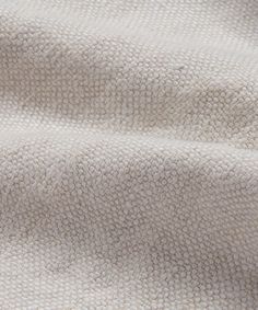 a close up view of the texture of a white fabric with small circles on it