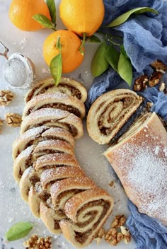 an assortment of pastries and oranges on a table