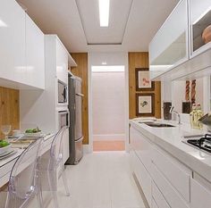 the kitchen is clean and ready to be used for cooking or dining, with all white appliances