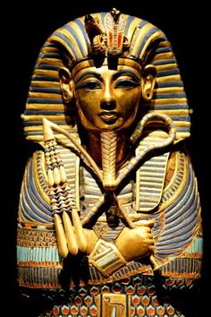 an egyptian statue is shown against a black background