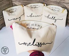 four personalized canvas bags sitting on top of a table