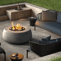 an outdoor fire pit surrounded by chairs and tables