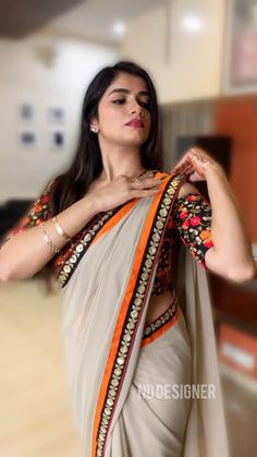 a woman in a sari posing for the camera