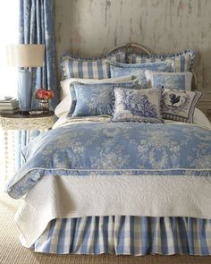 a bed with blue and white comforters in a room