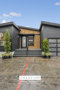 a house with two garages and steps leading up to the front door is shown