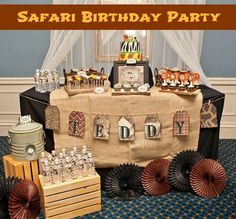 a safari birthday party is set up with decorations and desserts for the guests to enjoy