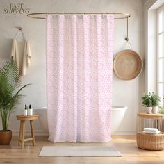 a bathroom with a pink shower curtain next to a toilet