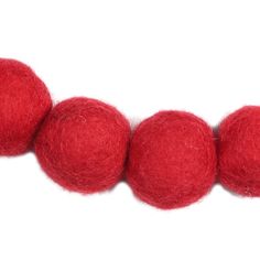 three balls of red wool sitting on top of each other