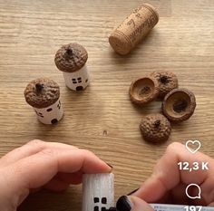 a person holding a remote control next to some corks and other items on a table