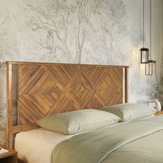 a bedroom with a bed, nightstands and wallpaper on the walls behind it