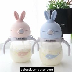 two baby bottles with bunny ears on them