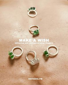 four rings are arranged on the back of a woman's stomach with words that read make a wish